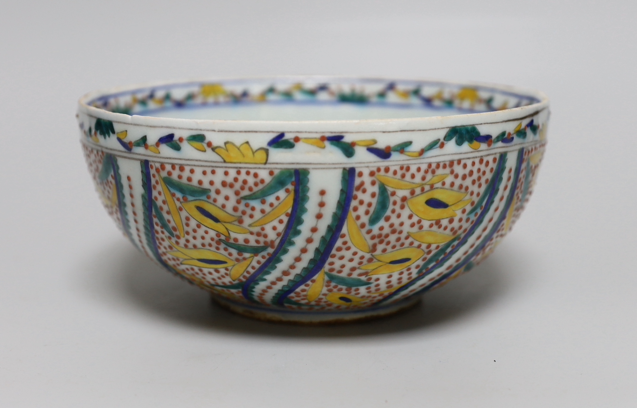 A Turkish Kutahya bowl hand painted with stylised flowers, 19cm in diameter